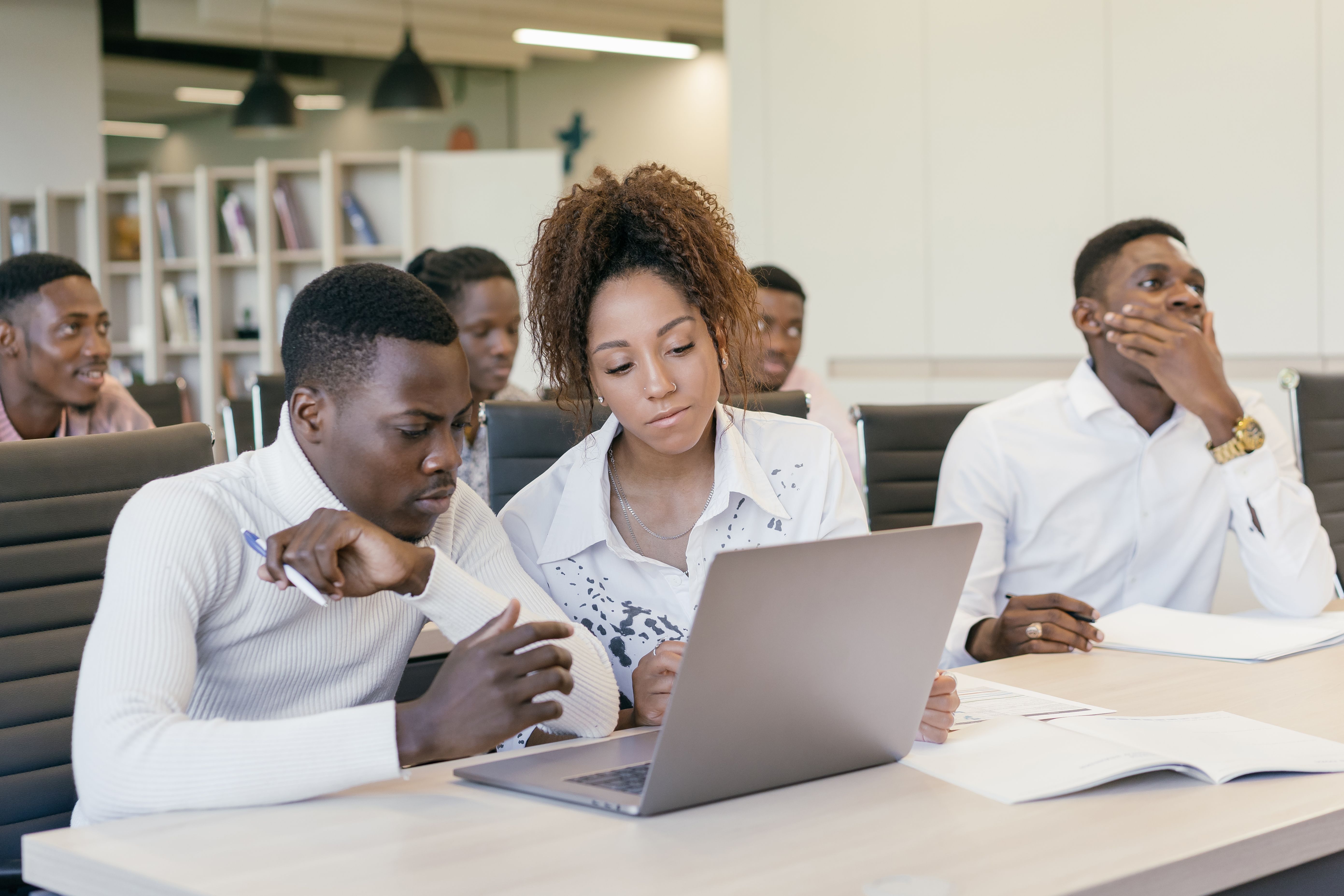 A team collaborating together over a laptop